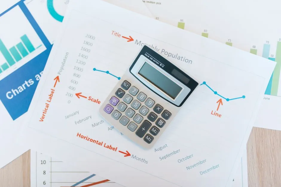 A calculator resting on top of financial paperwork