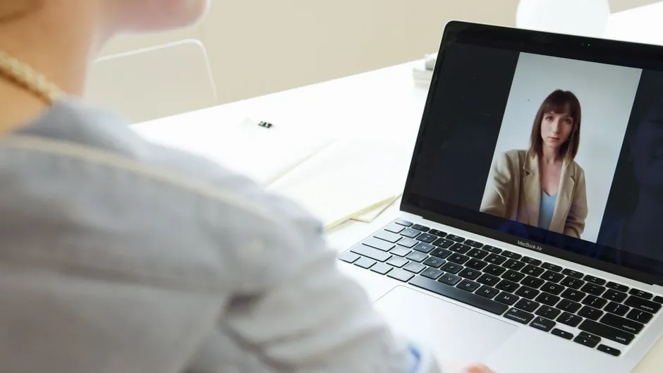 A woman taking part in a video call on a laptop